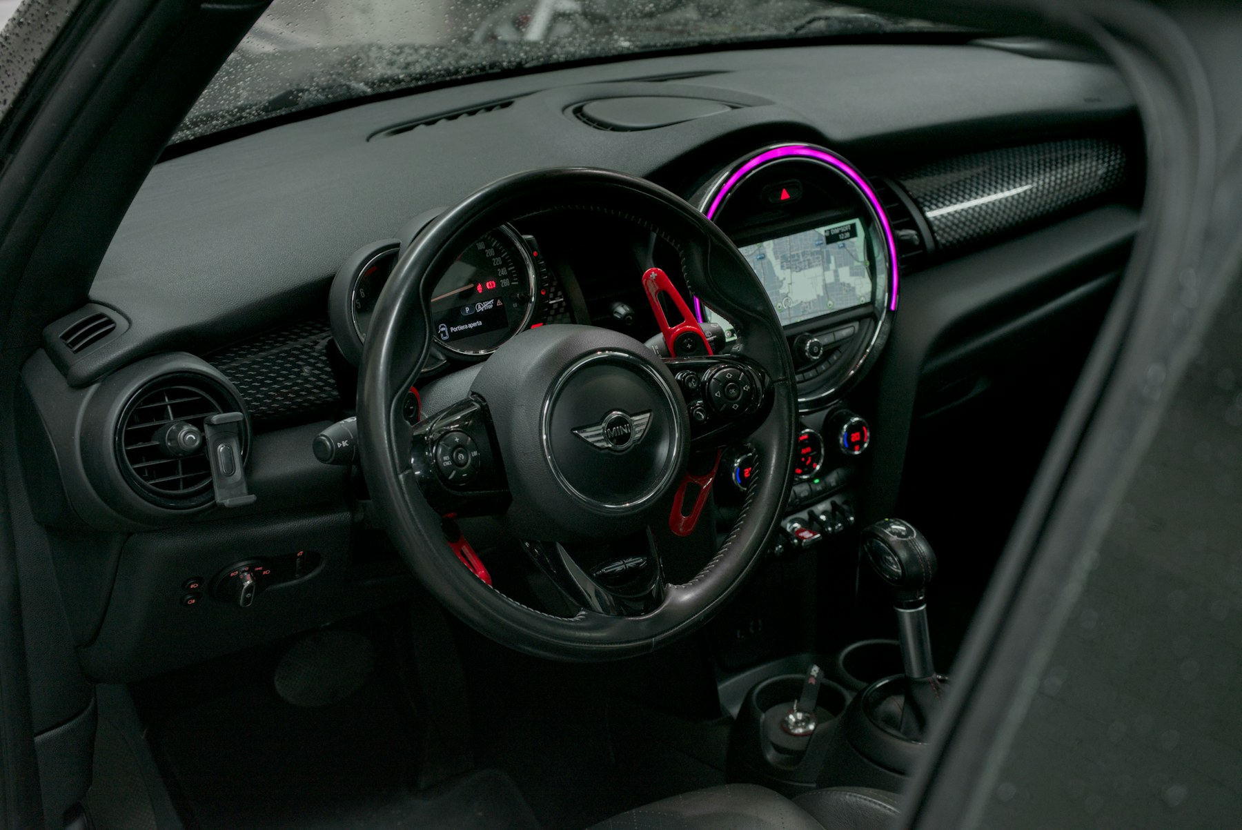 Modern car dashboard and steering wheel viewed from the front seats