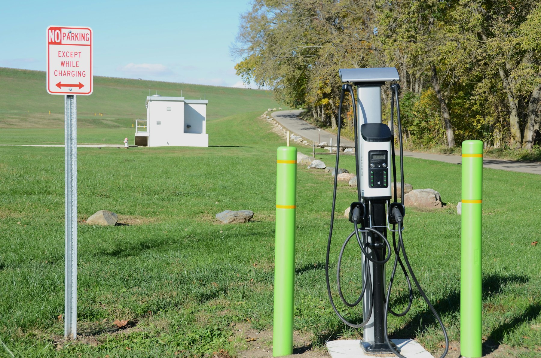 Electric vehicle charging station in a grassy outdoor setting
